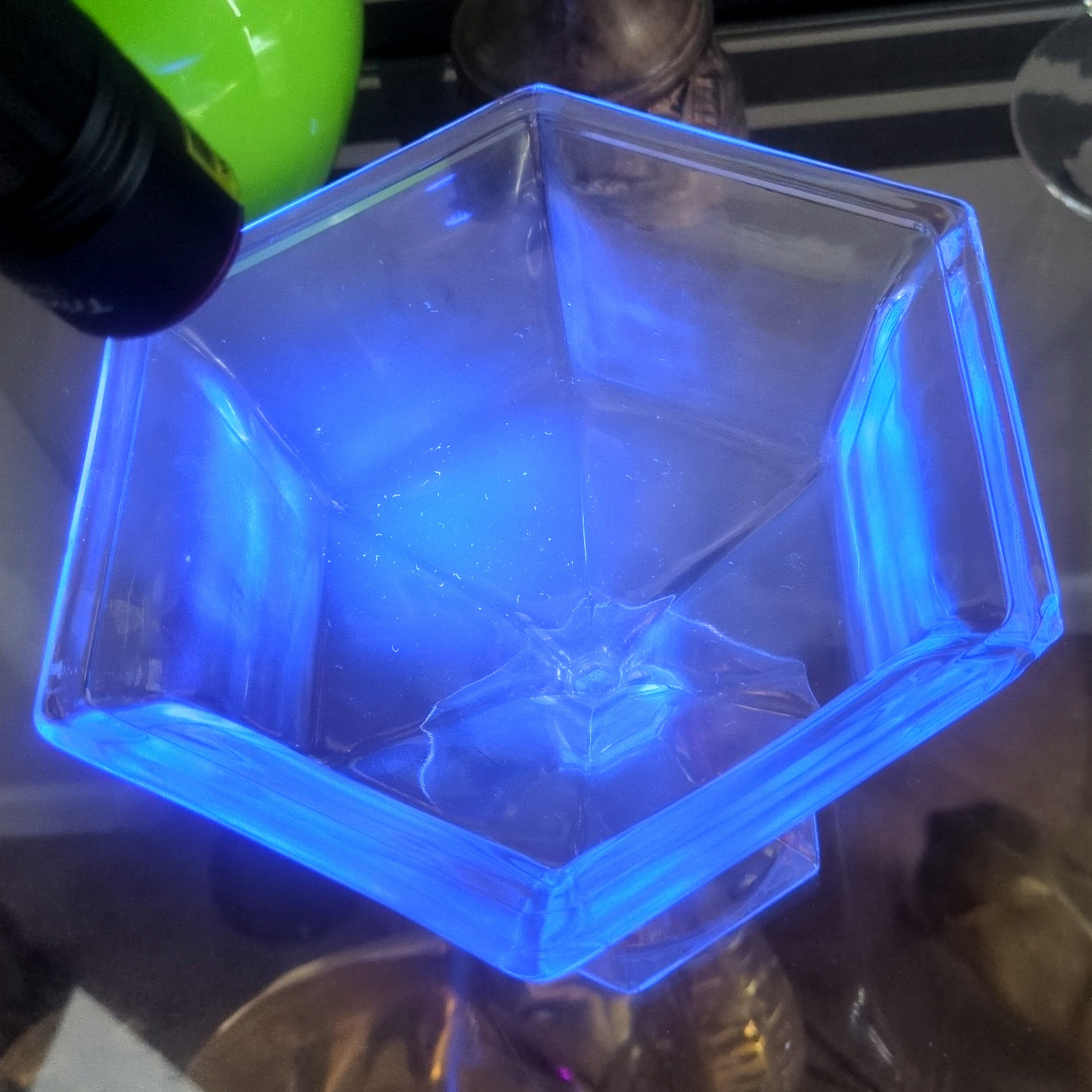 vintage clear pressed-glass octagonal pedestal compote  that glows blue under a 365 UV light.