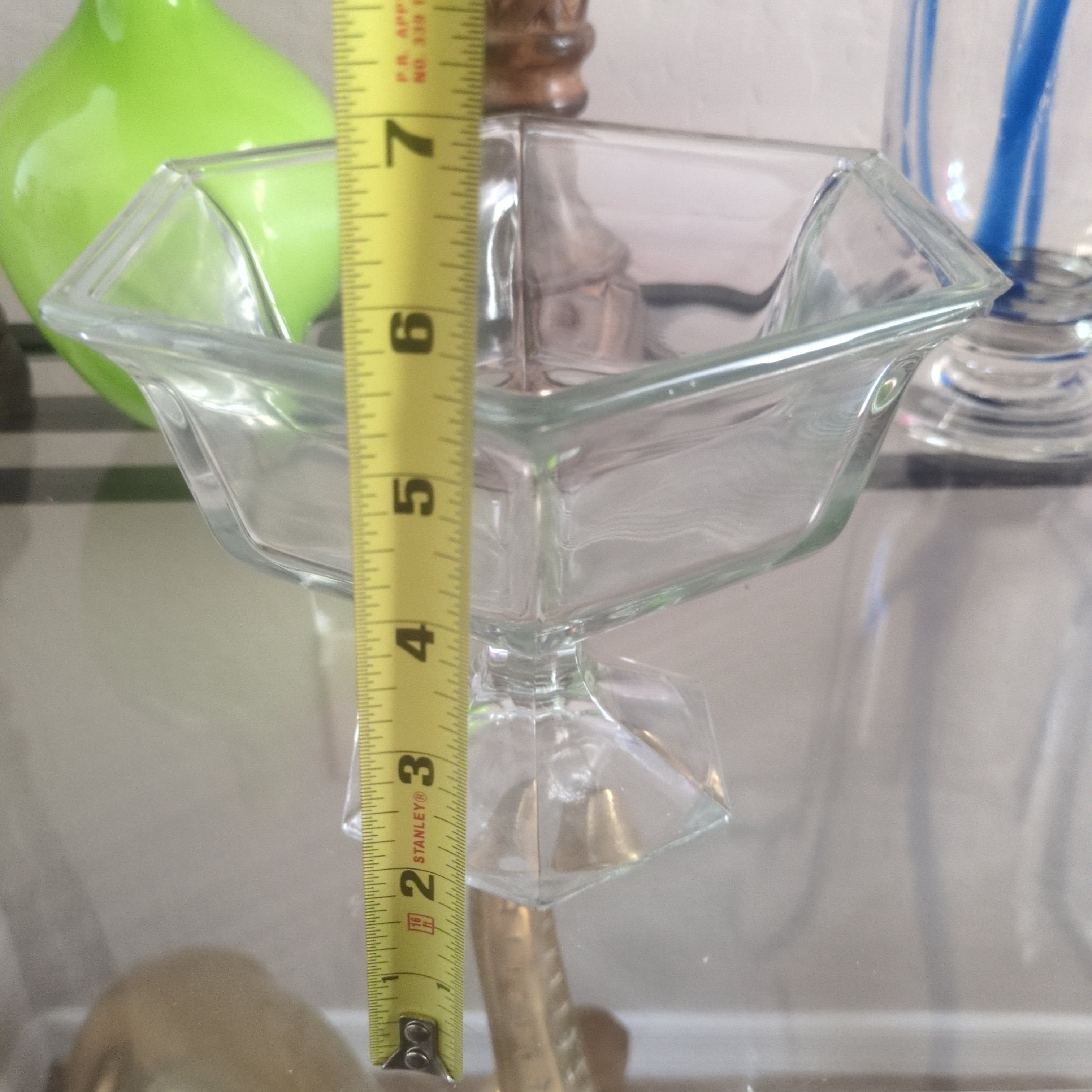 vintage clear pressed-glass octagonal pedestal compote  that glows blue under a 365 UV light.