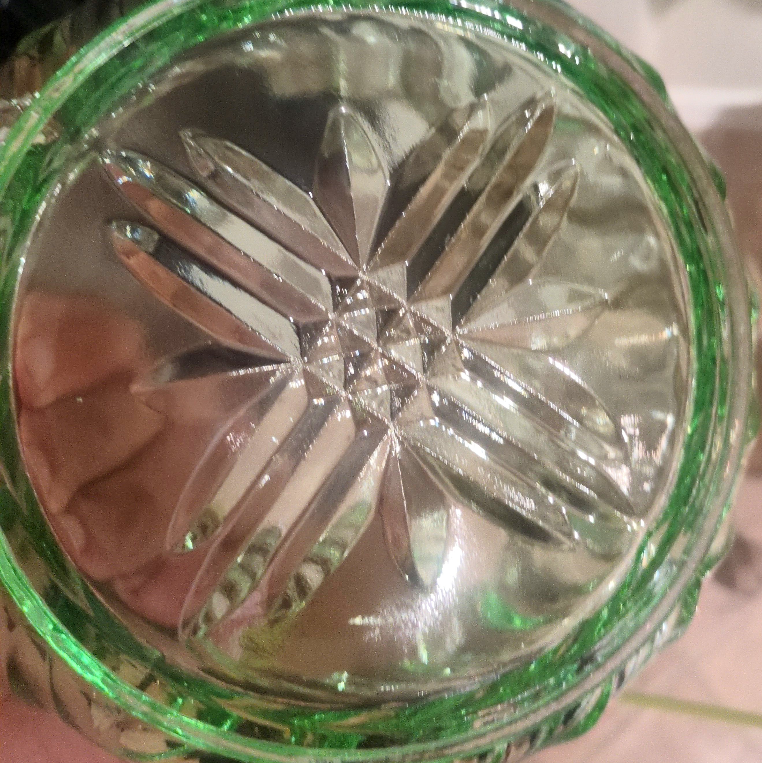 vintage emerald green pressed glass bowl with a scalloped rim.