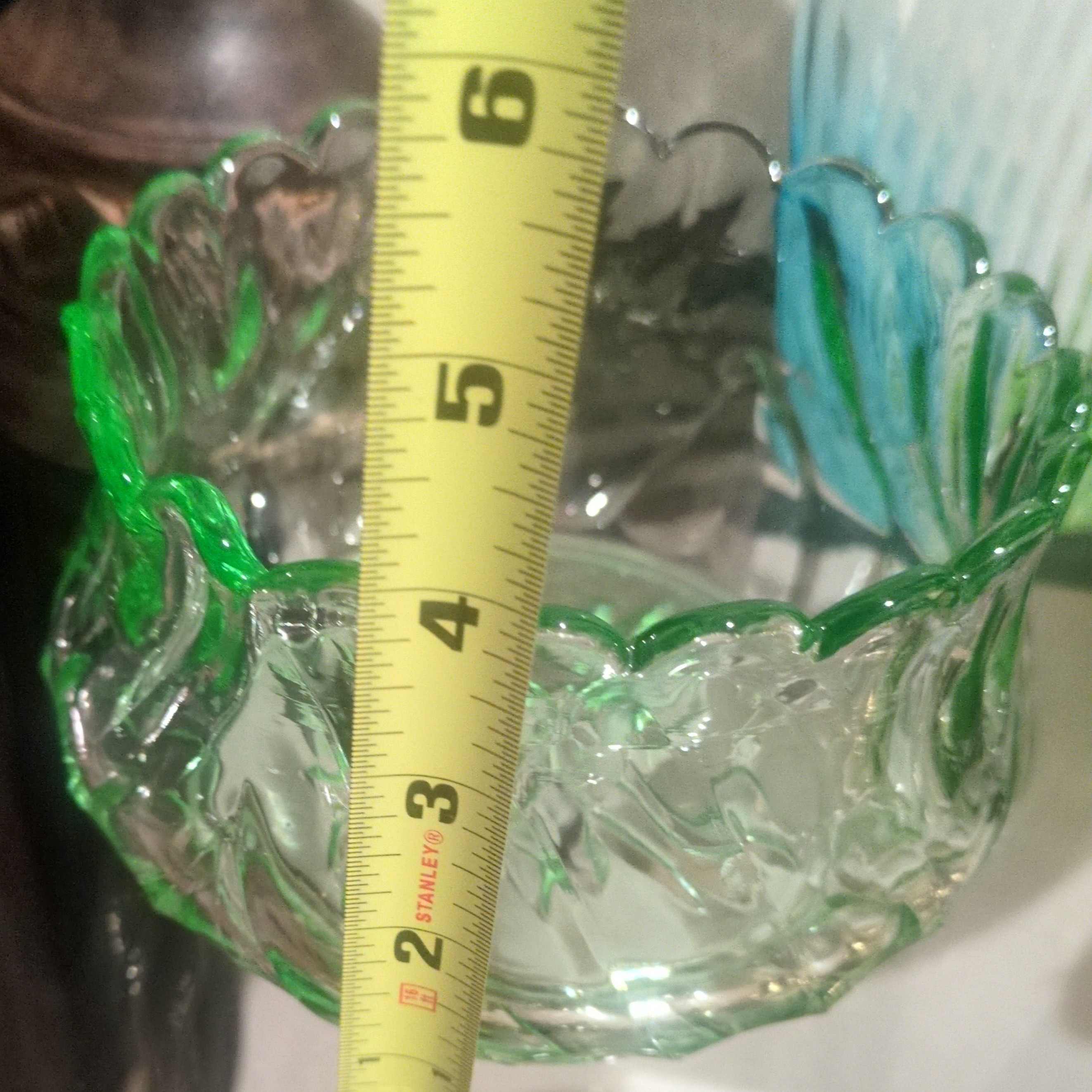 vintage emerald green pressed glass bowl with a scalloped rim.