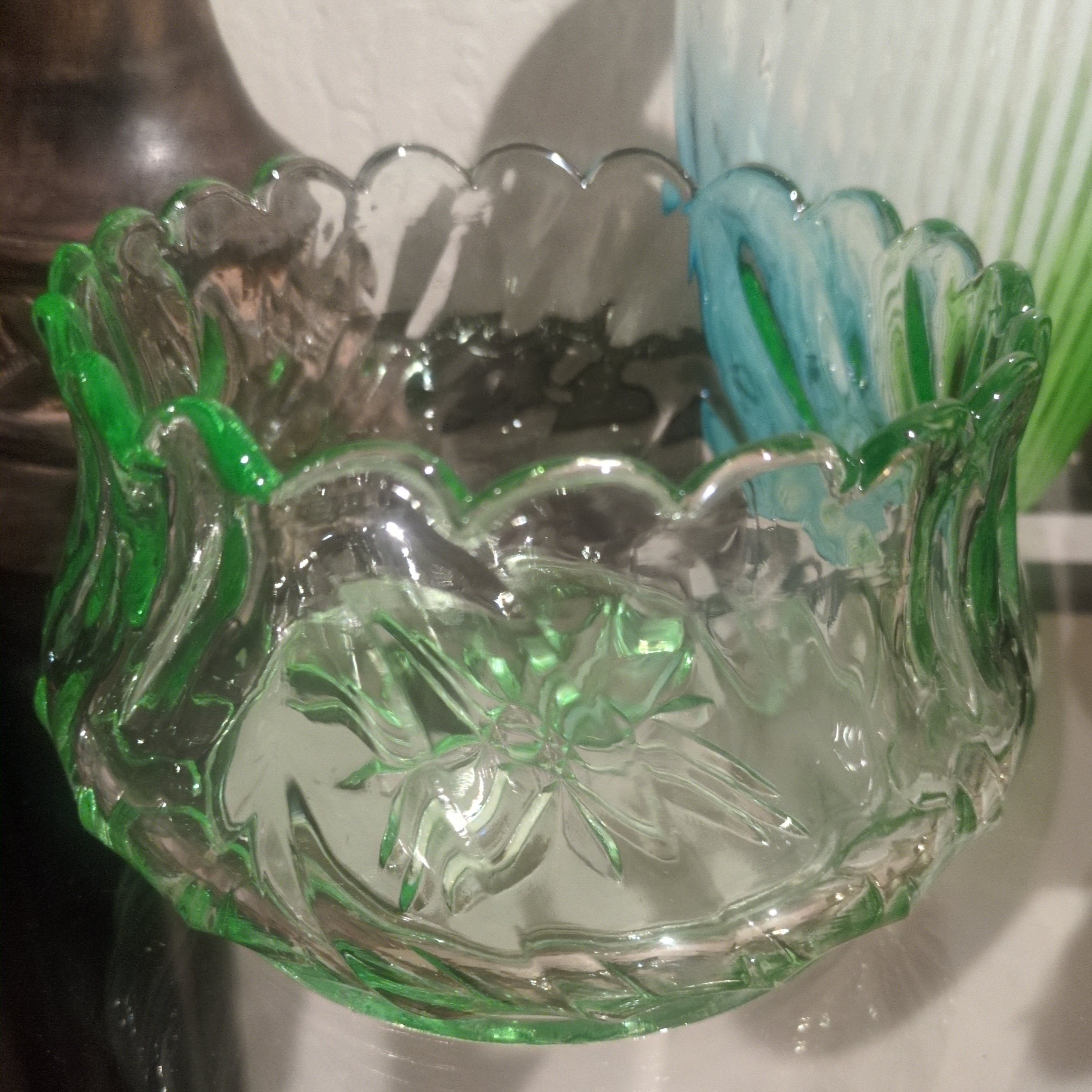 vintage emerald green pressed glass bowl with a scalloped rim.