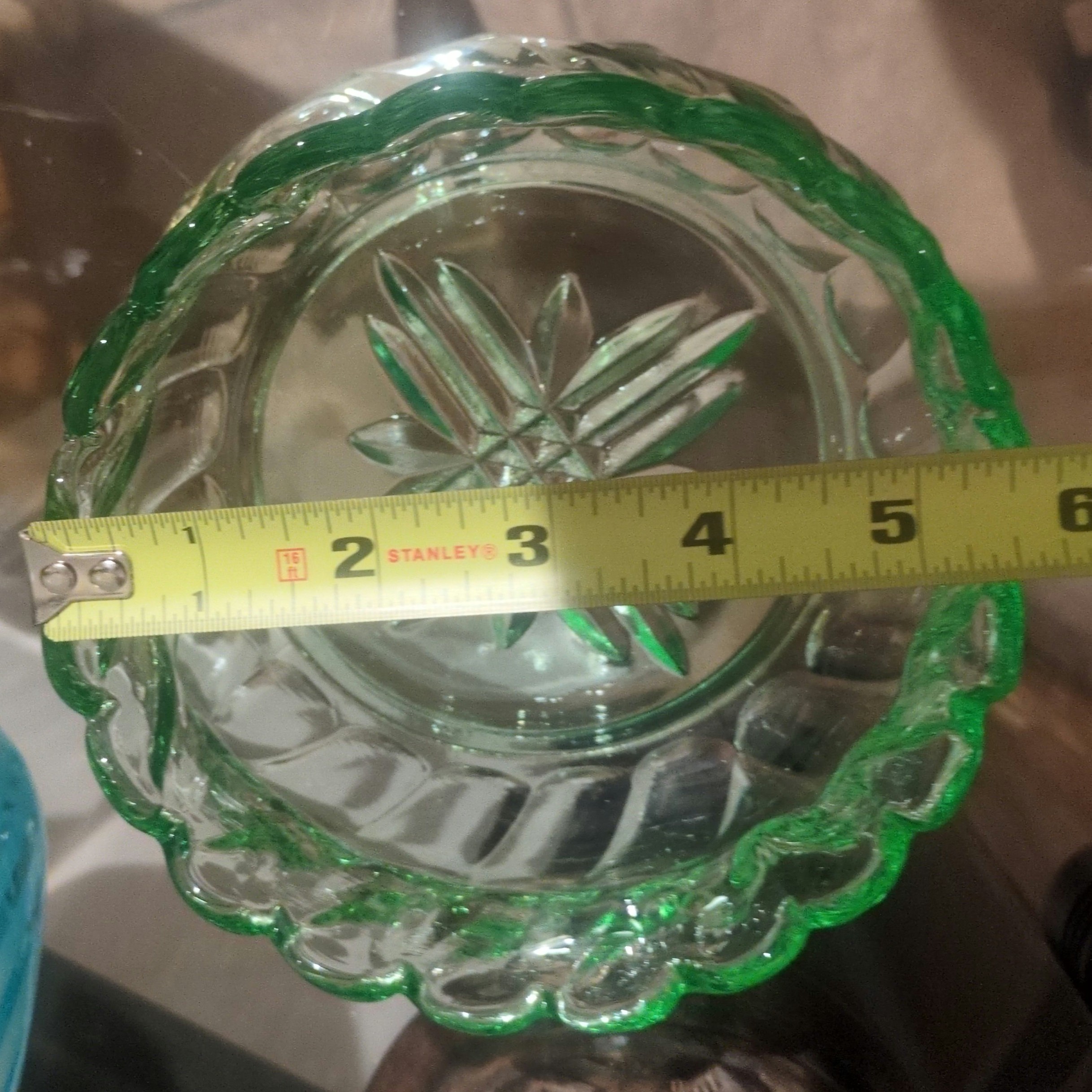 vintage emerald green pressed glass bowl with a scalloped rim.