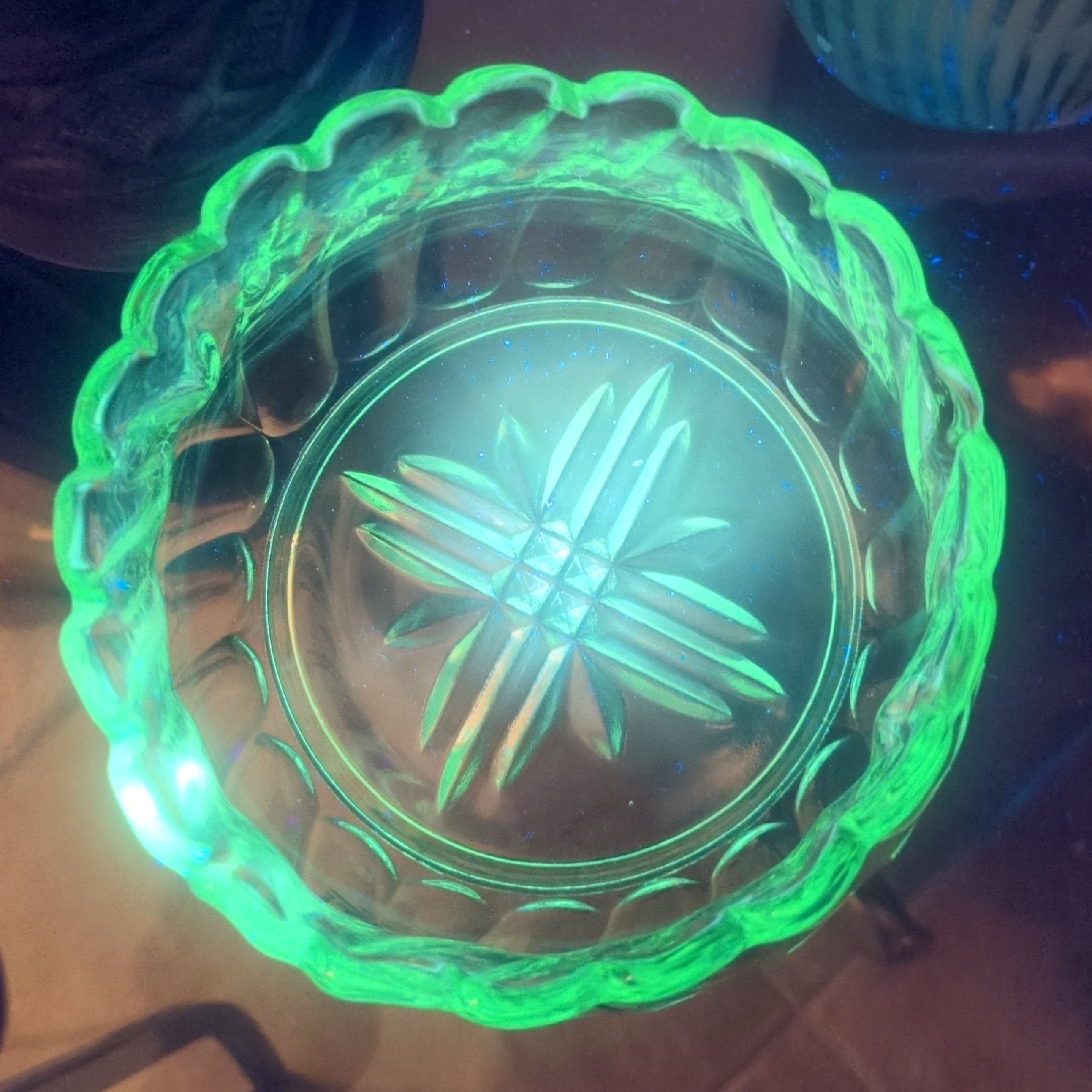vintage emerald green pressed glass bowl with a scalloped rim.